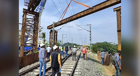 BMRCL personnel erect an open steel web girder, above the railway tracks, near Baiyappanahalli in Bengaluru on Sunday | Express 