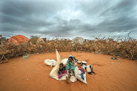 A Somali woman and child wait to be given a spot to settle at a camp for displaced people amid a drought on the outskirts of Dollow in Somalia on September 20, 2022. (Photo | AP)
