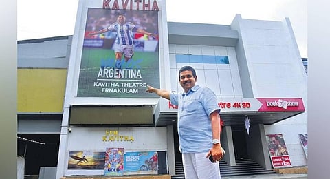 Saju Johny, owner of Kavitha theatre, in front of Argentinian football player Lionel Messi’s hoarding at the theatre complex at MG Road in Kochi | A Sanesh