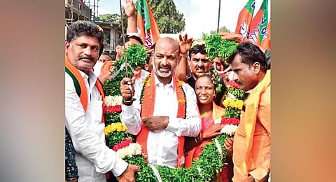 Supporters welcome BJP State president Bandi Sanjay whose Praja Sangrama Yatra reached the outskirts of Karimnagar on Wednesday