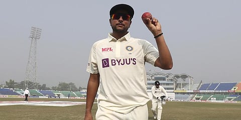 India's Kuldeep Yadav shows the ball after taking five wicket during the first Test cricket match day third between Bangladesh and India.(Photo | AP)