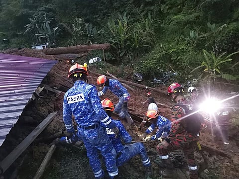 Civil Defense personnel search for survivors buried after a landslide hit a campsite in Batang Kali, Malaysia on Dec. 16, 2022. (Photo | AP)