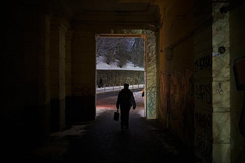 A man walks during a power outage in Kyiv, Ukraine on Dec. 15, 2022. (Photo | AP)