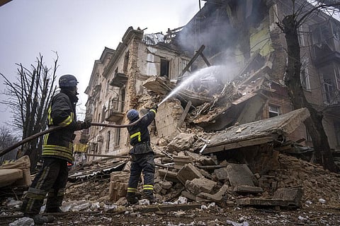 Ukrainian State Emergency Service firefighters work to extinguish a fire at the building which was destroyed by a Russian attack in Kryvyi Rih, Ukraine. (Photo | AP)