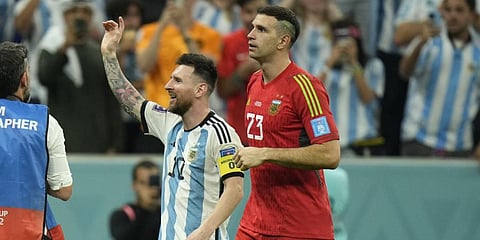 Argentina's Lionel Messi and goalkeeper Emiliano Martinez celebrate after defeating the Netherlands off penalties during the World Cup quarterfinal.(Photo | AP)