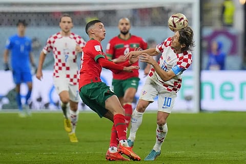 Morocco's Bilal El Khannous, left, and Croatia's Luka Modric fight for the ball during the World Cup third-place playoff at Khalifa International Stadium in Doha, Qatar, Dec. 17, 2022. (Photo | AP)
