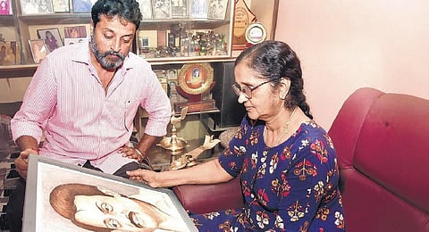 Sujatha Soman and Saji Soman, wife and son of the late actor M G Soman, look at his picture at their house in Tiruvalla | Shaji Vettippuram