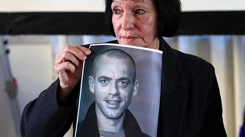 'We didn't think it was possible to deport somebody from his birthplace,' said Denise Guidoux, pictured with a photo of her son Salah Hamouri. (File Photo | AFP)