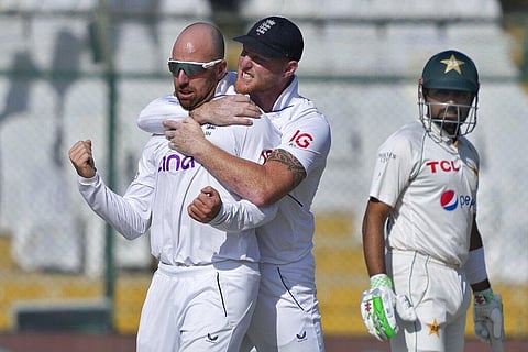 England's Jack Leach celebrates with teammate Ben Stokes, after taking the wicket of Pakistan's Abdullah Shafique during the third day of third test cricket match. (Photo | AP)