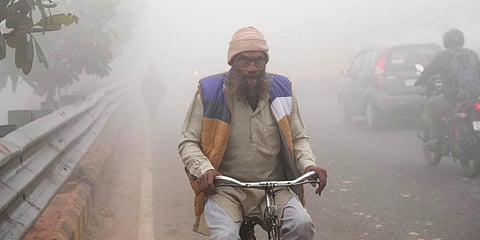 A commuter on a road amid dense smog on a cold winter morning, in New Delhi, Monday, Dec. 19, 2022.