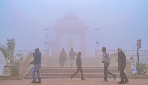 Locals during their morning walk amid dense fog and a cold winter morning, in Kanpur. (Photo | PTI)