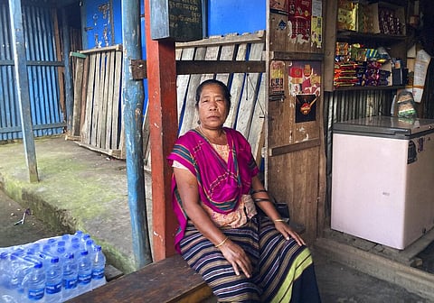 Tribal woman Modhumala Chakma, sits in front of a shop in Rangamati district of Bangladesh | AP