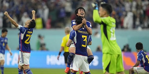 Japan players celebrate at the end of the World Cup group E soccer match between Japan and Spain.(Photo | AP)