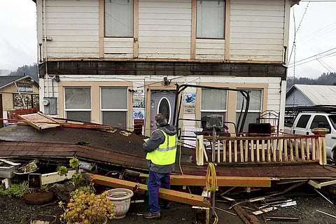 Building inspector Kevin Caldwell, red tags a home in Rio Dell, California, that lost an awning and deck, after an earthquake hit Humboldt County on Dec. 20, 2022 | AP