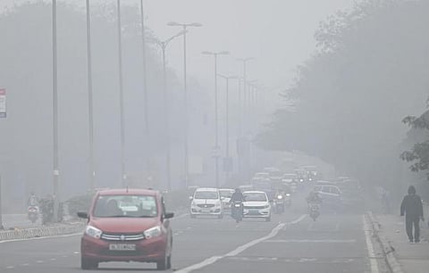 Commuters drive amidst morning smog in New Delhi on Wednesday. (Photo | Shekhar yadav, EPS)