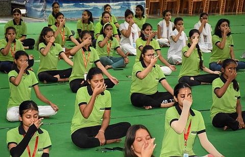 Students participate in a yoga session, in Kota. (Photo | PTI)