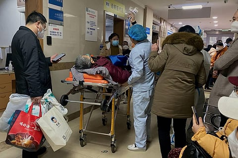 A Covid-19 patient on a stretcher in the emergency ward of the First Affiliated Hospital of Chongqing Medical University in China. (AFP)