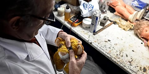 Antonio Martinez Rivas, 70 years old, fixes a 'Lion King' soft toy at his workshop 'Hospital del Juguete' (Toys hospital), in Madrid .(Photo | AFP)