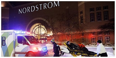Two first responders and an ambulance are seen at the entrance to Nordstrom at the Mall of America in Bloomington. (Photo |AP)