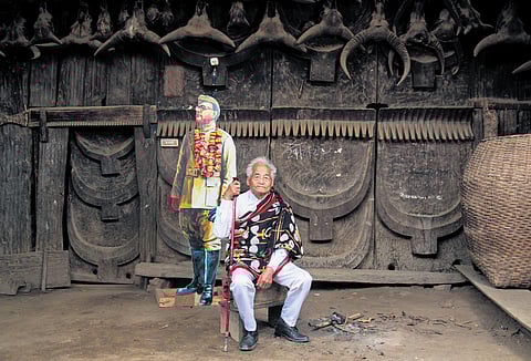 Poswuyi Swuro near a Netaji cutout in the house where the INA chief stayed for nine days. (Photo | Mongmei L Phom)