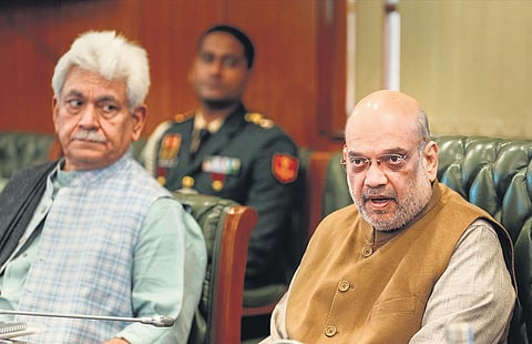 Home Minister Amit Shah (right) with Jammu and Kashmir L-G Manoj Sinha during a meeting on Jammu and Kashmir, in New Delhi on Wednesday. (Photo | PTI)
