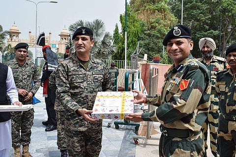 BSF and Pakistan Rangers exchange sweets on the occasion of Eid at Joint Check Post at Hussainiwala in Punjab on Tuesday. (File Photo | ANI Twitter)