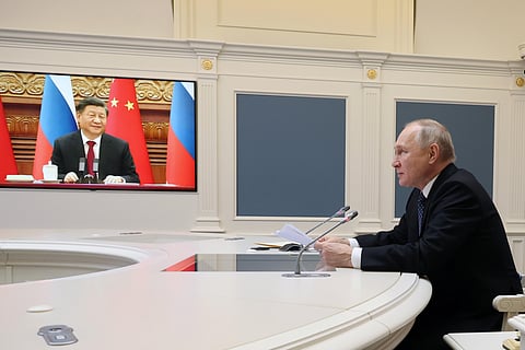 Russian President Vladimir Putin speaks during a meeting with Chinese President Xi Jinping, seen onscreen, via a video conference at the Kremlin in Moscow. (Photo | AP)