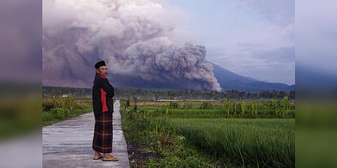 A man looks on as Mount Semeru releases volcanic materials during an eruption on December 4, 2022 in Lumajang, East java, Indonesia. (Photo | AP)