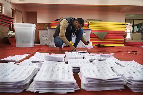 An election commission staff separates ballot papers to count a day after the general election in Kathmandu, Nov. 21, 2022. (File Photo | AP)