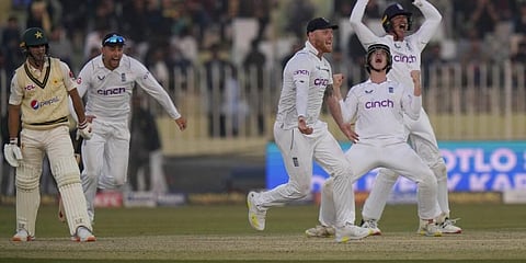 England's players celebrate after the dismissal of Pakistan's Naseem Shah, (L), during the fifth day of the first test cricket match in Rawalpindi, Dec. 5, 2022. (Photo | AP)