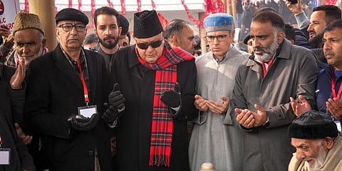J&K National Conference President Farooq Abdullah, (C), with Omar Abdullah at the party founder Sheikh Mohammad Abdullah's mausoleum in Srinagar, Dec. 5, 2022. ( Photo | PTI)