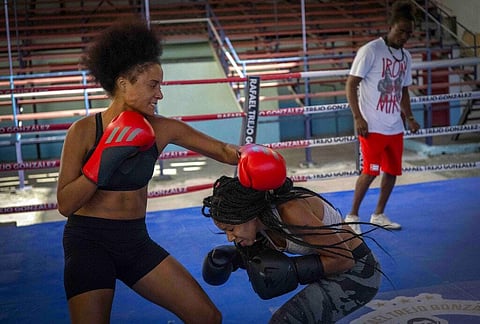 Boxer Giselle Bello Garcia, (L), throws a punch at Ydamelys Moreno during a training session in Havana, Cuba, Dec. 5, 2022. (Photo | AP)