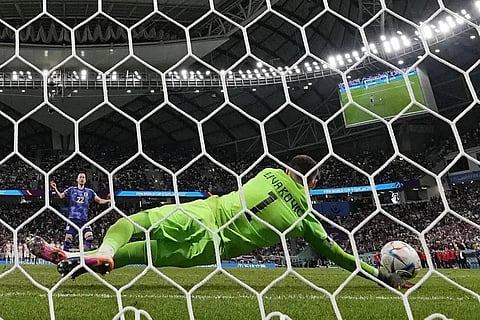 Croatia's goalkeeper Dominik Livakovic saves from Japan's Maya Yoshida during a penalty shootout at the end of the World Cup round of 16 match at the Al Janoub Stadium, Dec 5, 2022. (Photo | AP)