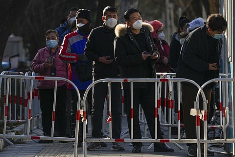 Residents wait in line for their routine COVID-19 test at a coronavirus testing site | AP