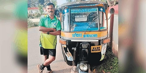 Soccer Suresh stands beside his autorickshaw named after football legend Diego Maradona.(Photo | Express)