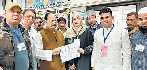 Congress’ Shagufta Chaudhary, who won from Chauhan Bangar in northeast Delhi, with her father-in-law and others | Express