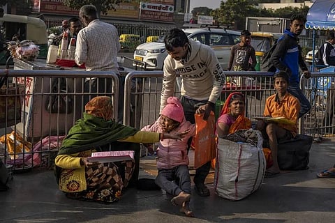 Savita Devi, left, tends to her sick daughter Srishtri Kumari, as they squat outside the All India Institute of Medical Sciences (AIIMS) hospital in New Delhi, India, Dec. 7, 2022. (Photo | AP)