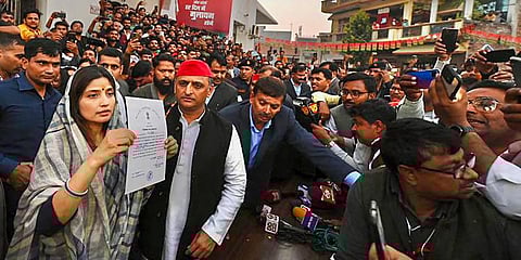 Samajwadi Party's Dimple Yadav with her husband and party President Akhilesh Yadav shows the 'certificate of election' after her victory in Mainpuri bypolls, Dec. 8, 2022. (Photo | PTI)