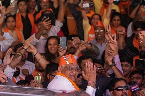 Gujarat Chief Minister Bhupendra Patel greets Bharatiya Janata party (BJP) supporters as they celebrate lead for the party in Gujarat state elections in Gandhinagar. (Photo | AP)