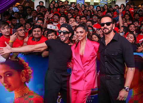 Actors Ranveer Singh and Deepika Padukone and director Rohit Shetty pose for photos during the song launch of their upcoming movie 'Cirkus'. (Photo | PTI)
