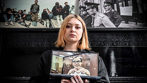 Alexandra Popova shows a photograph of her boyfriend Artyom Kamardin. (Photo | AFP)