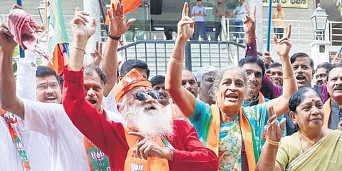 BJP workers celebrate the party’s victory in the Gujarat polls at the party office in Bengaluru on Thursday | Vinod Kumar T