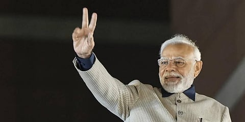 Prime Minister Narendra Modi flashes victory sign during the celebrations of BJP's victory in the Gujarat Assembly elections, at BJP headquarters in New Delhi. (Photo | PTI)