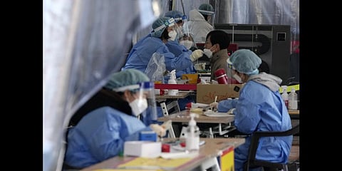 A worker moves boxes carrying Novavax Inc.'s COVID-19 vaccine at SK Bioscience Co. in Andong, South Korea.(Photo | AP)