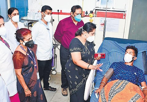 DMO K P Reetha checking on Babu at the district hospital in Palakkad