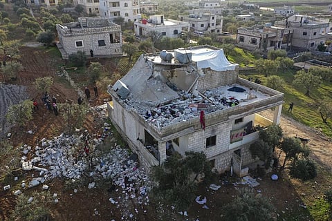 People inspect a destroyed house following an operation by the U.S. military in the Syrian village of Atmeh, in Idlib province, Syria. (Photo |AP)