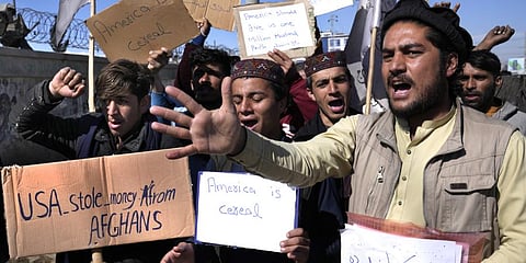 Afghan protesters hold placards and shout slogans against U.S. during a protest condemning President Joe Biden's decision, in Kabul.(Photo | AP)