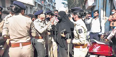 Police detain a protester at Surat on Saturday | Express