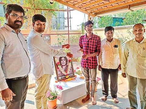 N Suresh Reddy of the Shyamala Gopalan Educational Society hands over the financial aid to Pammi Nagaraju in Khammam
