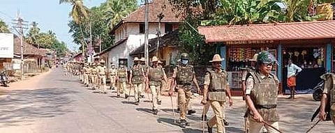 Policemen hold a route march in Gangolli town of Udupi district on Saturday